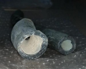 water slightly alkaline and slightly supersaturated in calcium carbonate in order to maintain a thin coating of solid carbonate on the interior of the pipe